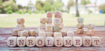 ENROLLMENT written on wood blocks 